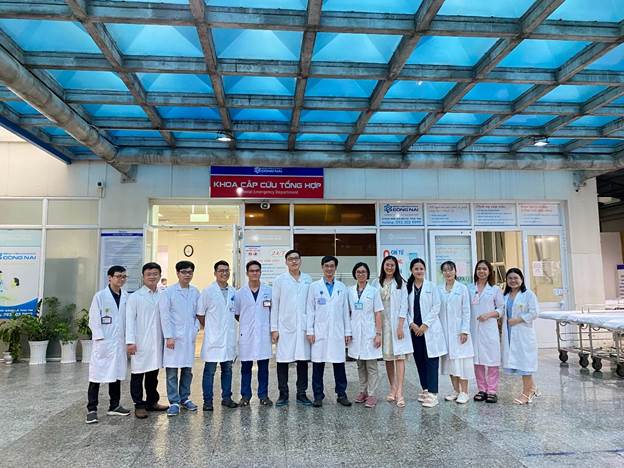 A group of people in white coats
Description automatically generated