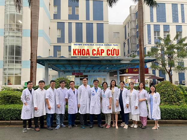 A group of people in white coats standing in front of a building
Description automatically generated with medium confidence