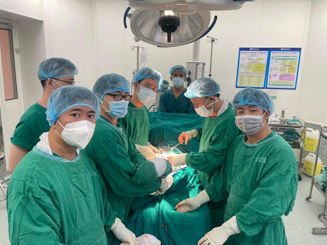 A group of people wearing surgical gowns and masks
Description automatically generated with low confidence